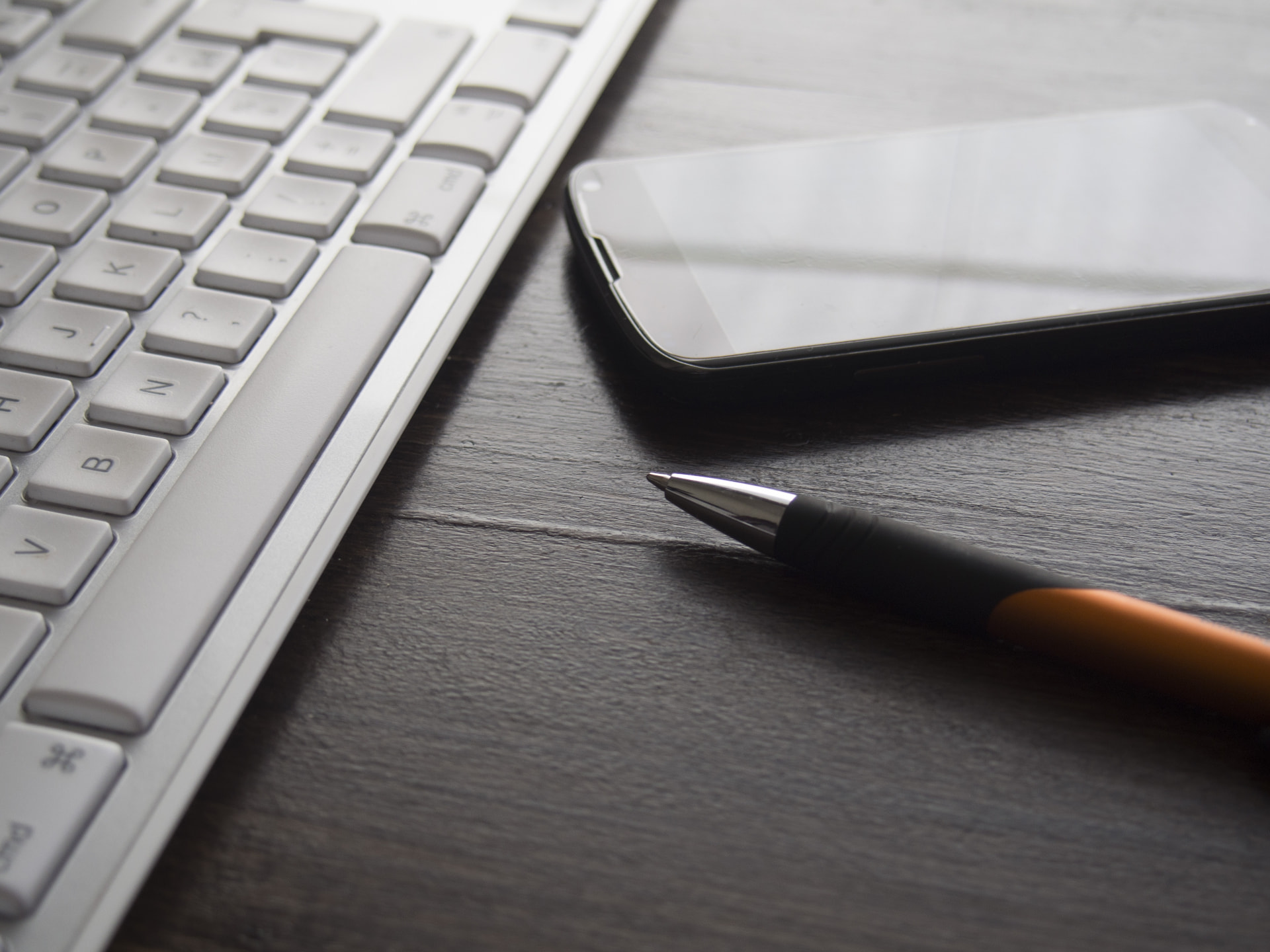 Desk with keyboard, phone and pen at our accountancy practice in Andover, Hampshire